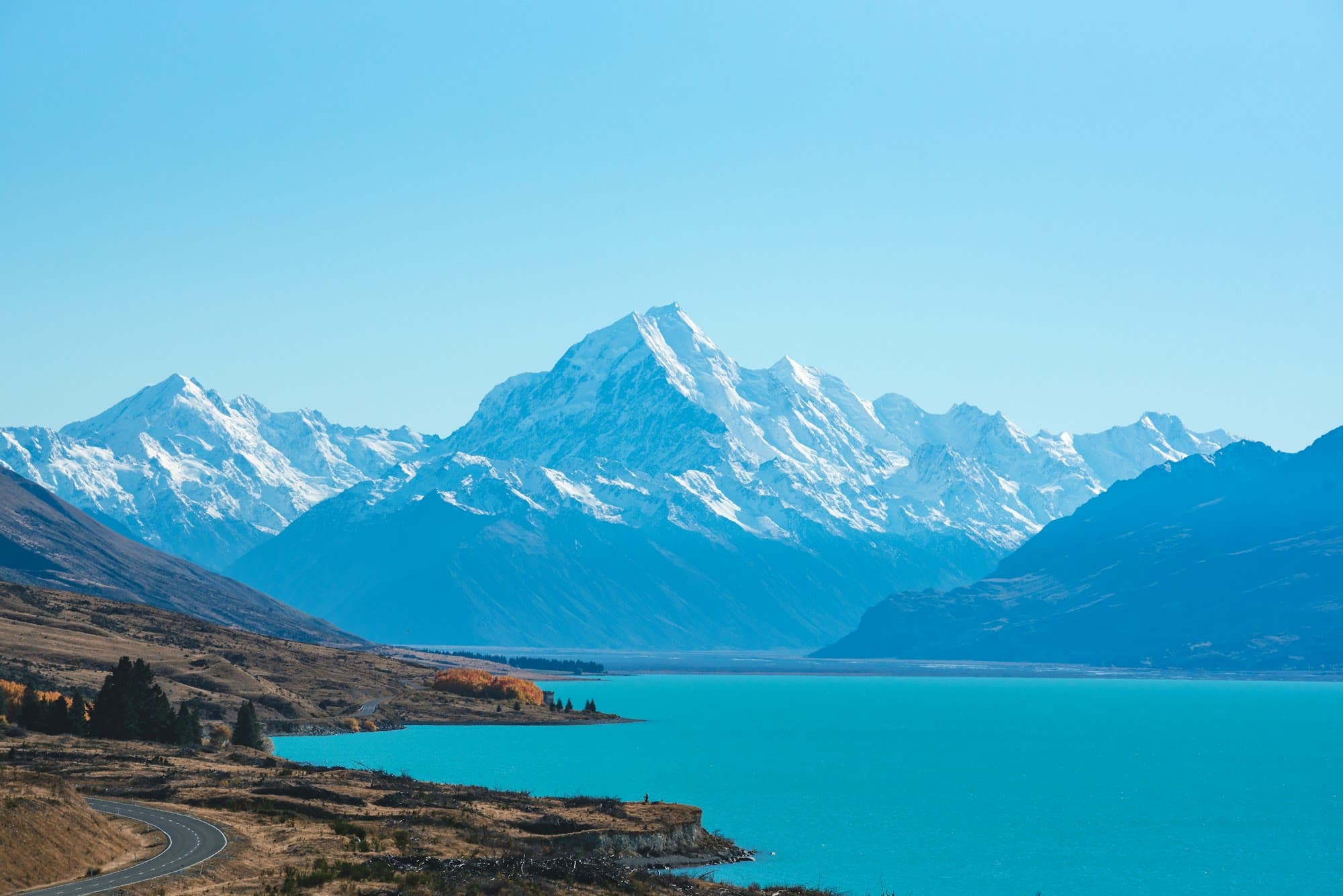 Turquoise water at Lake Pukaki, with snow-covered peaks behind it